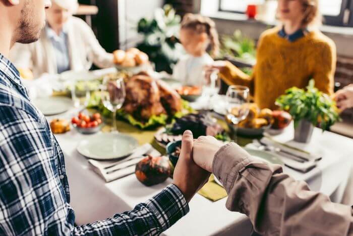 Family praying at Thanksgiving